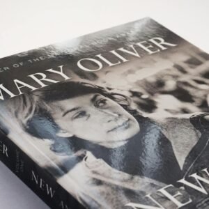 Close-up of a Mary Oliver poetry book with a vintage black and white cover.