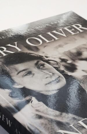 Close-up of a Mary Oliver poetry book with a vintage black and white cover.