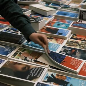 Person browsing books at a lively book sale in İzmit, Türkiye.
